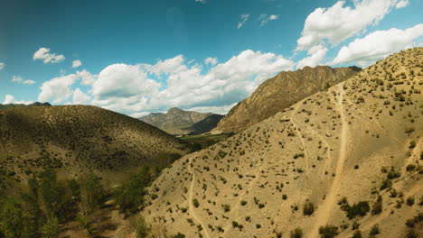 old mountain slope covered with tracks fpv drone. trekking footpath invites explorers to find adventures at highland under cloudy sky. wonderful landscape