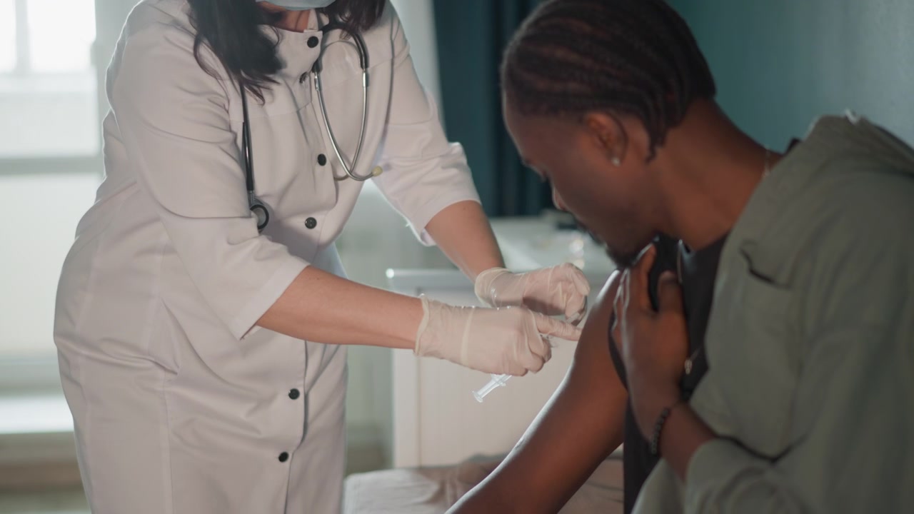 Gentle nurse giving shot at home. Peaceful home environment with nurse delivering vaccination safely. Serene setting where nurse carefully administers vaccine to patient in comfortable home