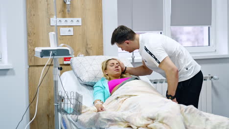 expecting couple in the maternity hospital before the childbirth. woman feels not well and her husband soothes her.