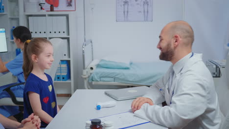 Friendly-doctor-doing-high-five-with-child