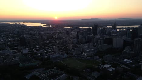 drone-shot-going-backward-from-Mont-Royal-lookout-in-Montreal-city-at-sunrise