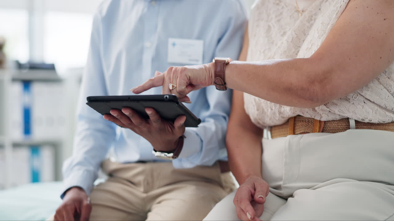 médico revisando los registros médicos con un paciente anciano