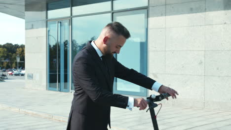 businessman riding an electric scooter in front of a modern office building