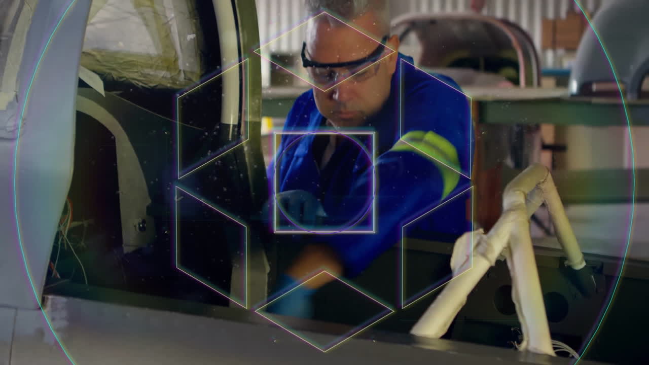 Man in blue uniform working on aircraft interior with geometric animation overlay