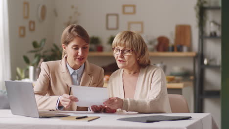 Portrait-of-Positive-Elderly-Woman-and-Female-Financial-Agent