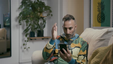 man with beard amazed by information viewed on his cell phone