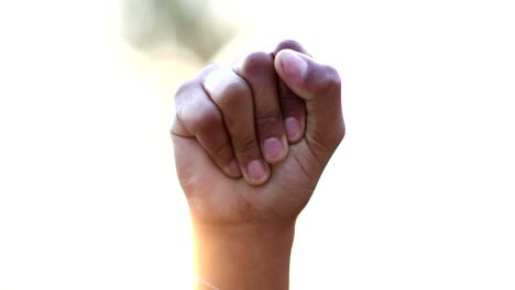 black hand raised fist in air in political protest, close-up clench fist