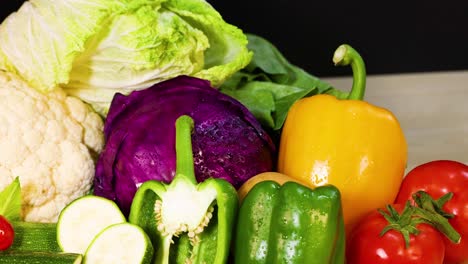 assorted vegetables arranged against a black background