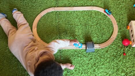 Two-year-old-afroeuropean-child-playing-with-his-toy-train-at-home