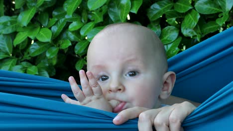baby boy playing in his bathtub outside