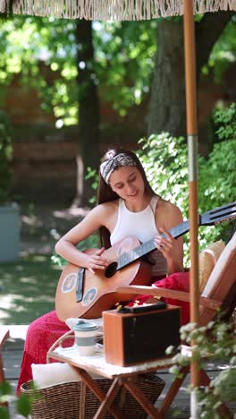 teenager playing guitar in a garden