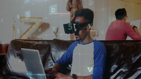 Man-wearing-a-virtual-reality-headset-while-typing-on-his-laptop-4k