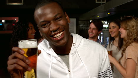 Handsome-man-holding-a-pint-at-a-party