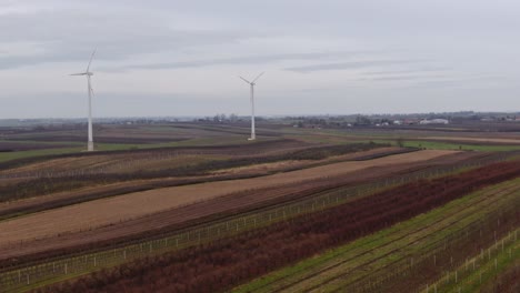 Electric-energy-produced-from-wind-turbines,-windmills-on-winter-fields-aerial-landscape