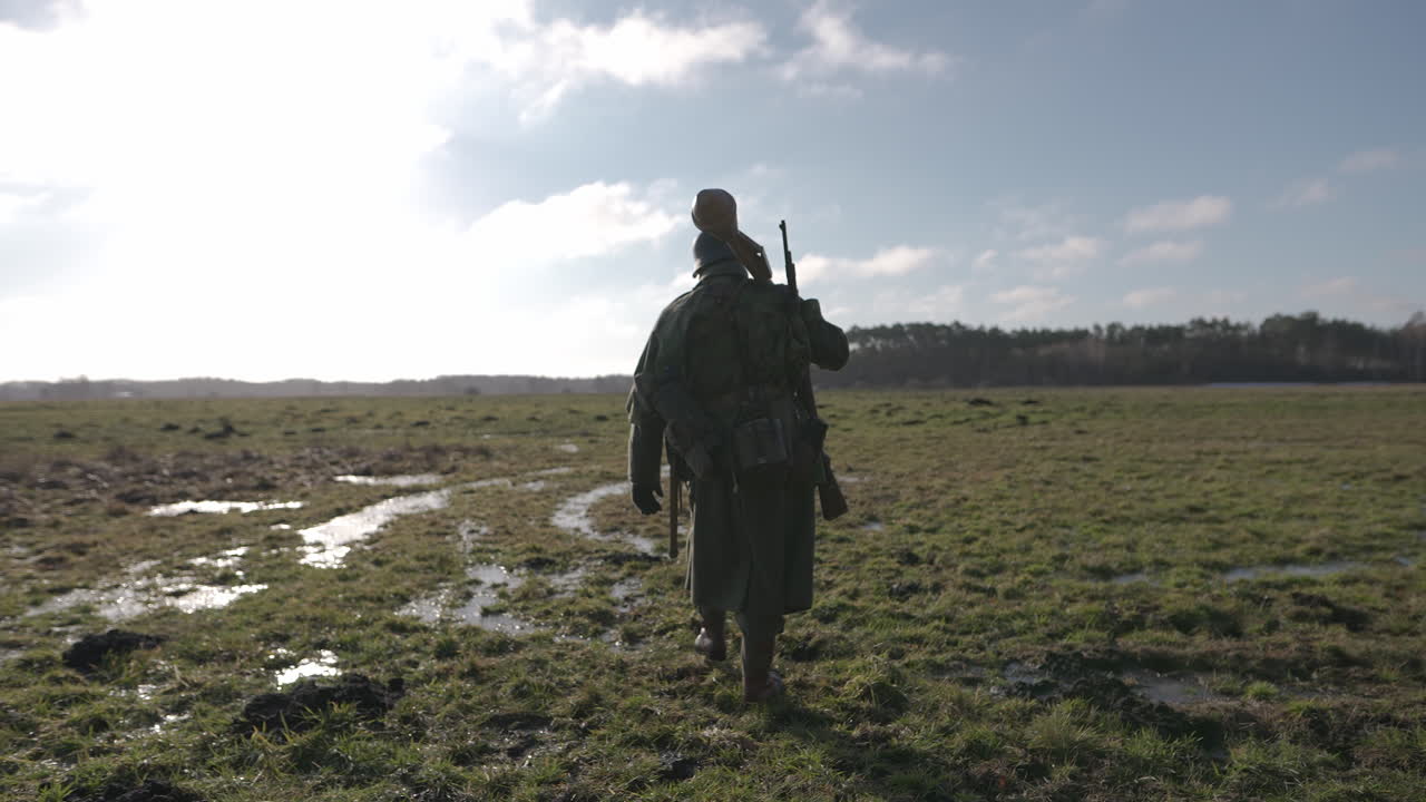 Soldier Walking Through a Muddy Field