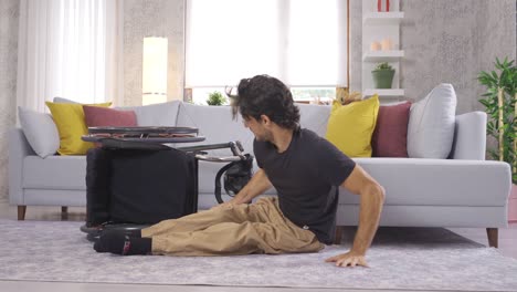 disabled young man falling from wheelchair to floor.