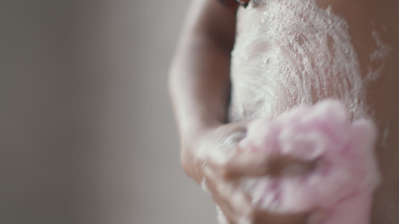Woman Washing Her Body with a Loofah
