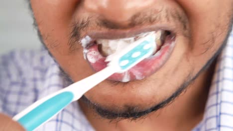 man brushing teeth