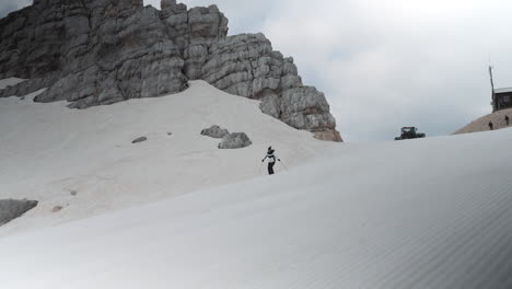 woman skiis downhill on mountain kanin on white snowy slopes