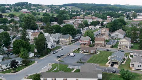 aerial of small town rural america, trailer park homes and older two story houses line street, establishing shot for united states usa neighborhood community development setting