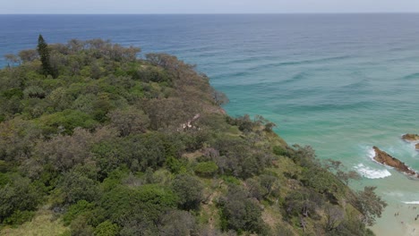 Headland-Park-With-People-Swimming-At-South-Gorge-Beach---Point-Lookout,-Queensland,-Australia