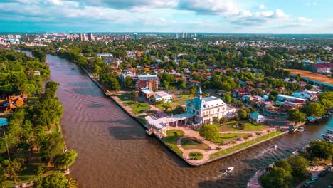 hyperlapse aerial orbit of the tigre art museum in argentina, reconquista river with small boats passing through the canals