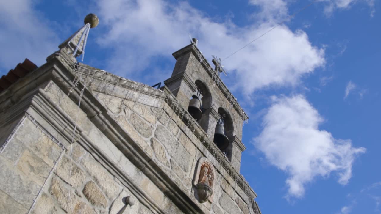 Bells tolling at church during a sunny day in Portugal