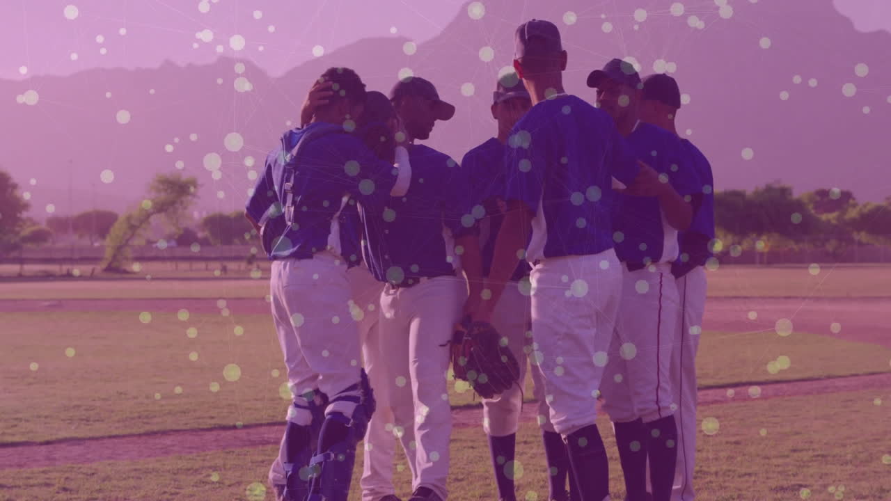 Baseball team huddling on field with colorful dot animation overlay