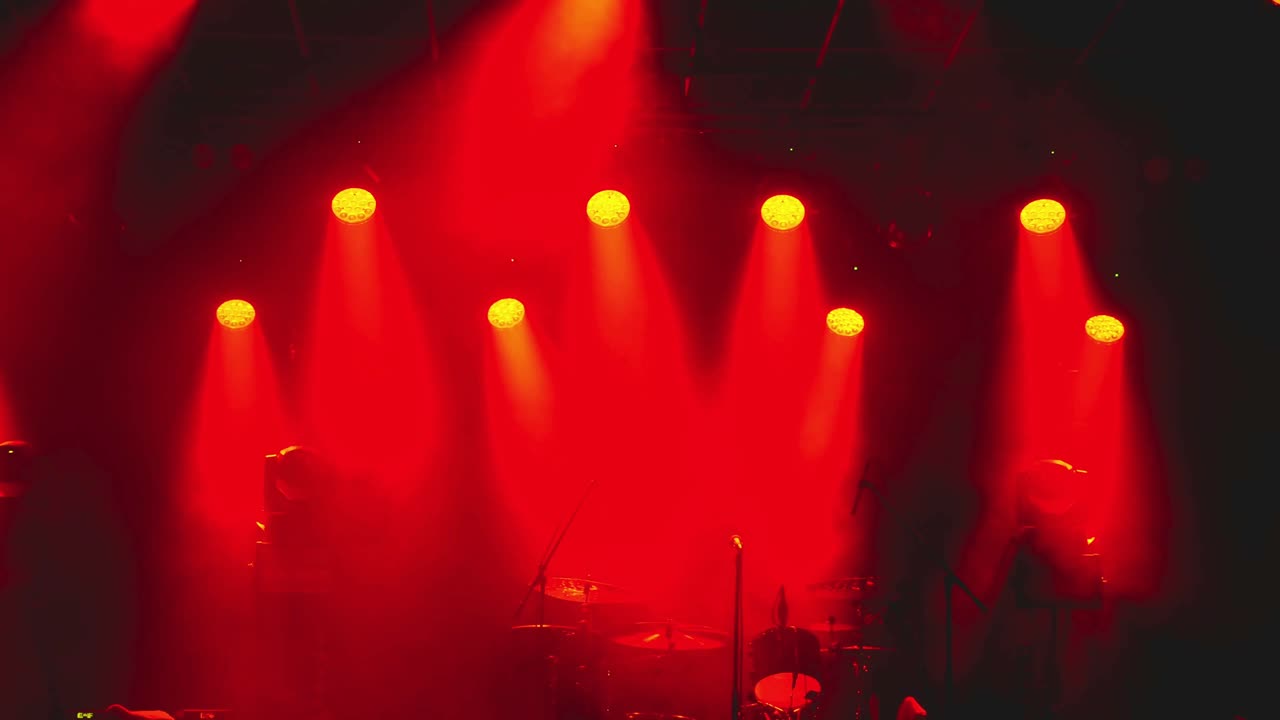 Dramatic Red Stage Lighting with Smoke and Musical Instruments