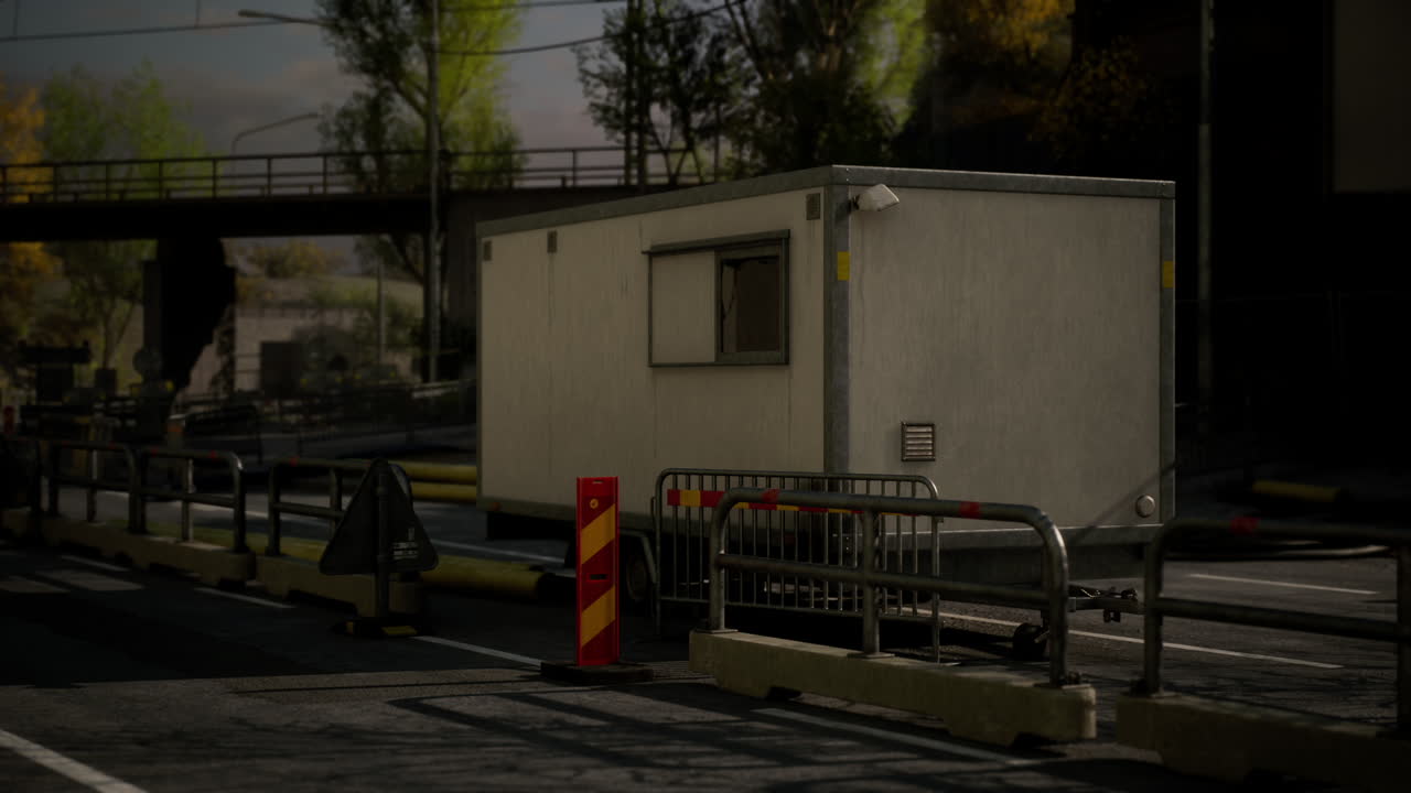 Traffic control booth situated near a highway under a bridge in daylight