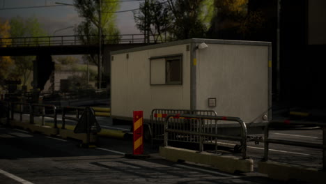 traffic control booth situated near a highway under a bridge in daylight