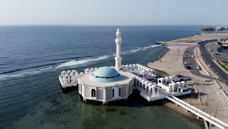 Beautiful-white-coastal-building-with-tower,-aerial-orbit-view