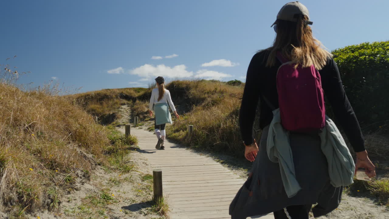 Mother and daughter hiking on a scenic coastal trail