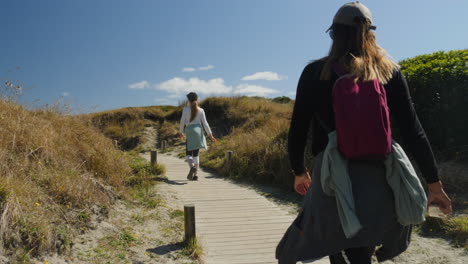 mother and daughter hiking on a scenic coastal trail
