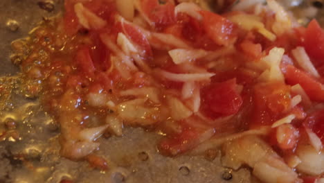 close up shot of cook preparing paella. the oil is boiling cooking the stir fry. shot in 4k