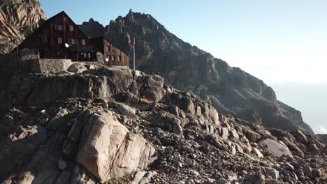 cabina orny en los alpes suizos con montañas rocosas durante una puesta de sol