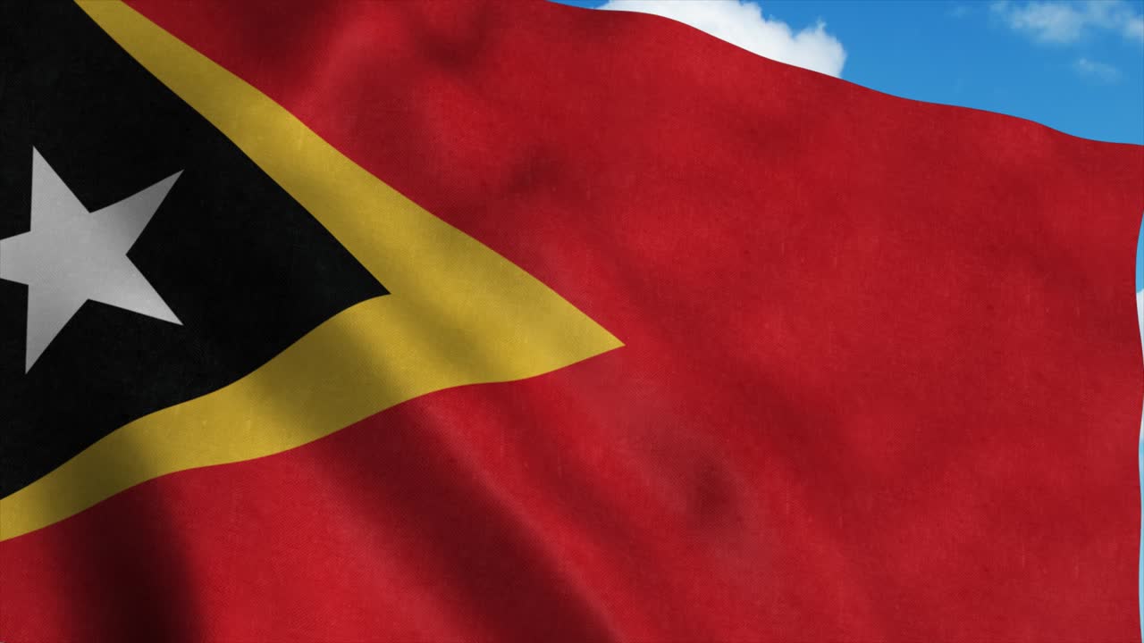 Østtimors flag vajende i vinden, blå himmel baggrund. 4K