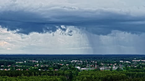 storm clouds pouring rain on cityscape, aerial time lapse view