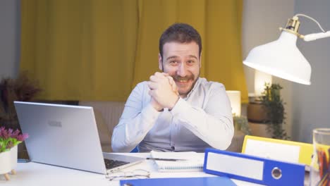 Home-office-worker-man-looking-at-camera-clapping-and-getting-excited.