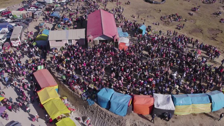 Daytime drone captures citizens gathering for the Tayta Shanti festival on Huaytapallana mountain in Huancayo, Peru