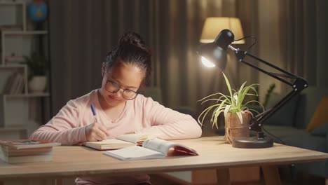 asian girl is studying at home, asia child doing homework at night