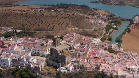 aerial views of a spanish town by a river and lake