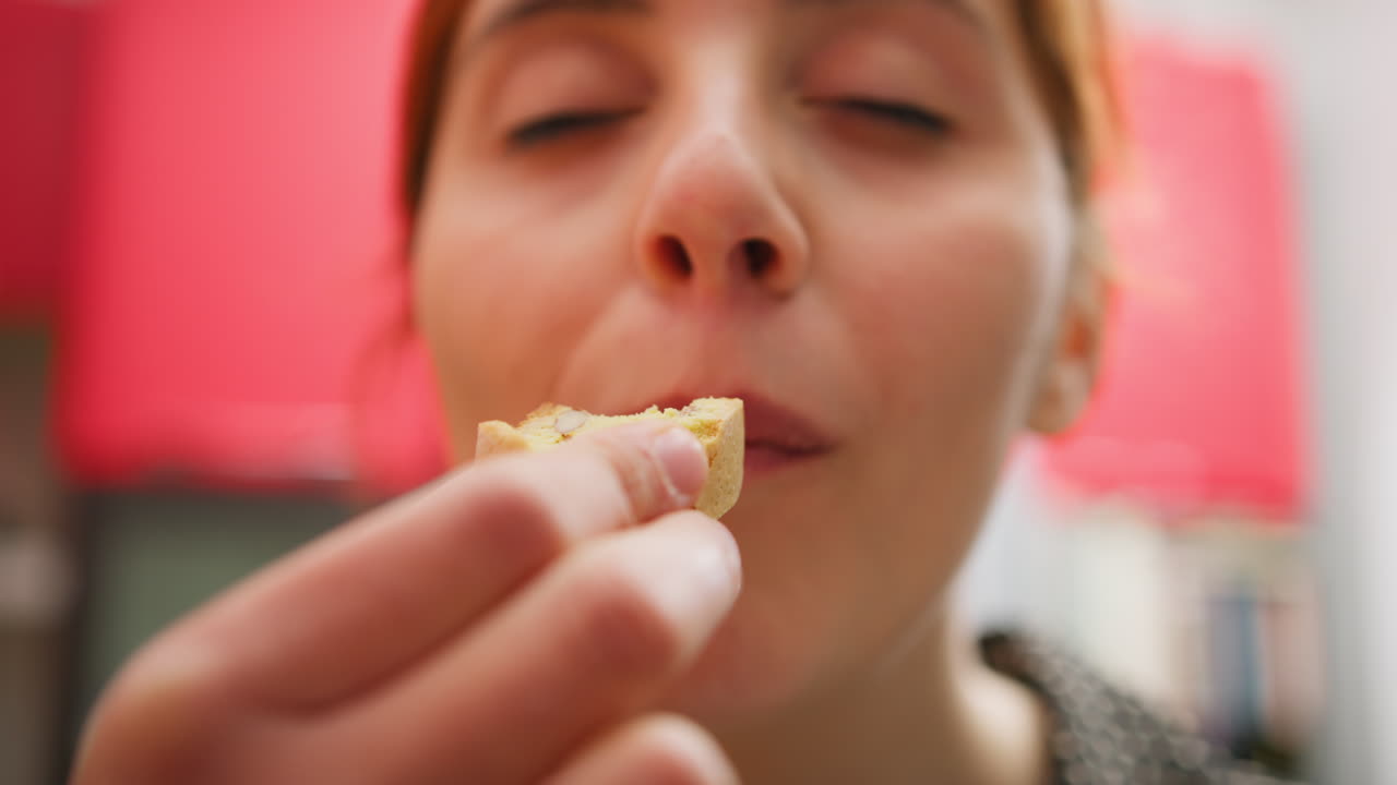 A Womans Hand Dips Biscuits Into Typical Indian Tea And Eat