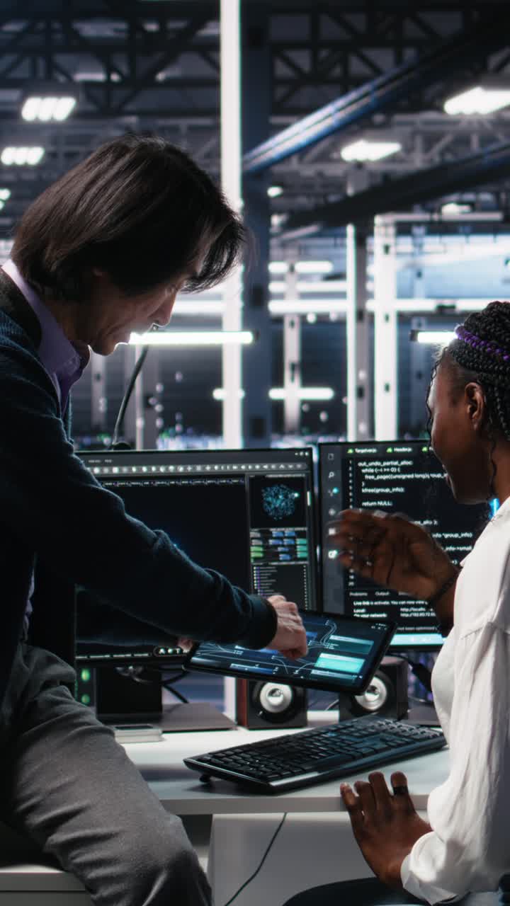 Vertical video Senior engineer and trainee in data center working on neural networks