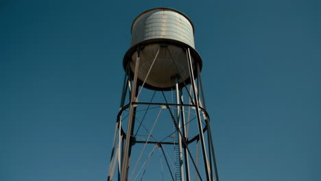 a tall water tower against a clear blue sky