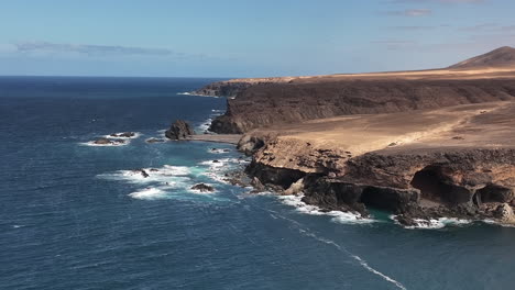 breathtaking views of fuerteventura with lobos island, red flag beach, kite surfers, sunsets, volcanoes, sand dunes, and wingfoilers in the canary islands’ golden light.
