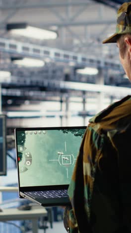 vertical video military technician in data center tracking satellite coordinates using notebook