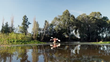 People,-kayak-and-rowing-on-a-lake-in-nature