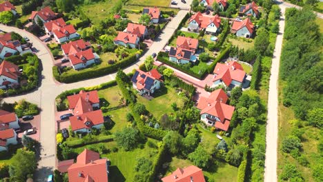 Aerial-view-of-residential-houses-neighborhood-and-apartment-building-complex-at-sunset