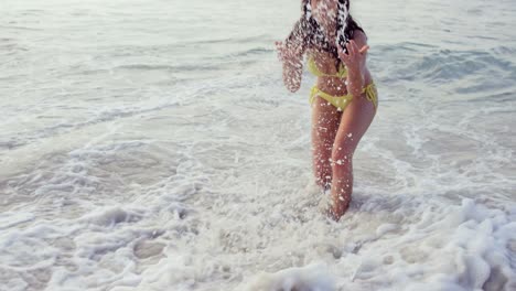 Smiling-young-woman-playing-with-waves